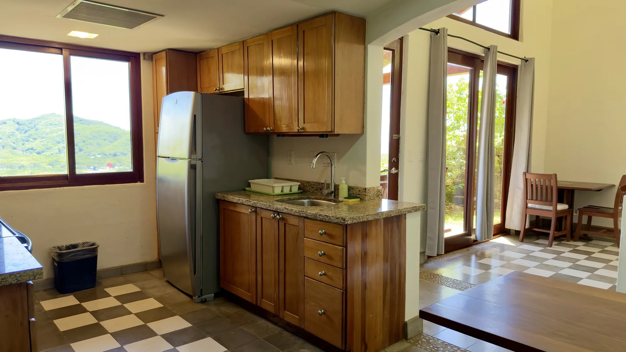 Equipped kitchen with wood cabinets and a view of the hills