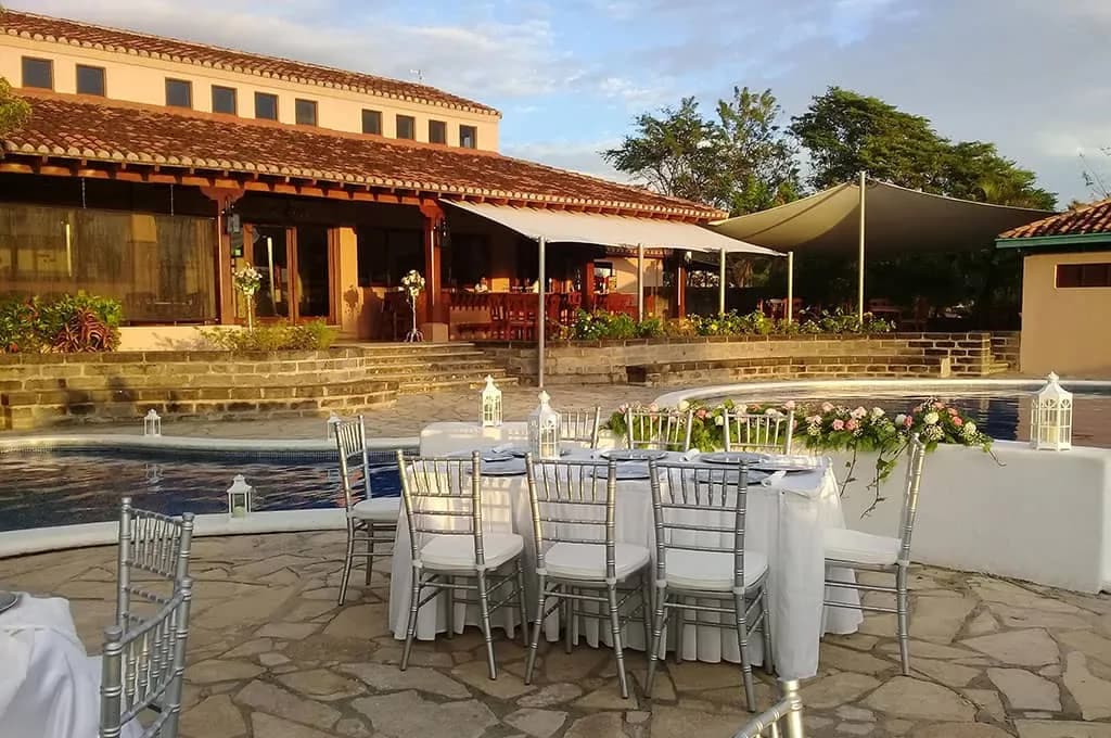 A wedding reception set up by the pool