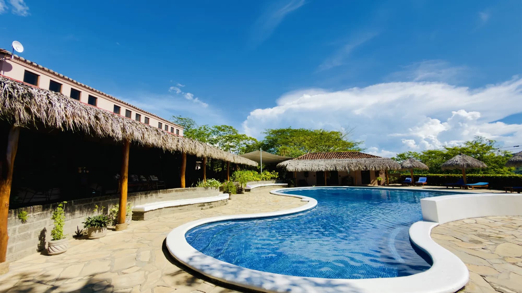 The curving pool beside the restaurant palapa