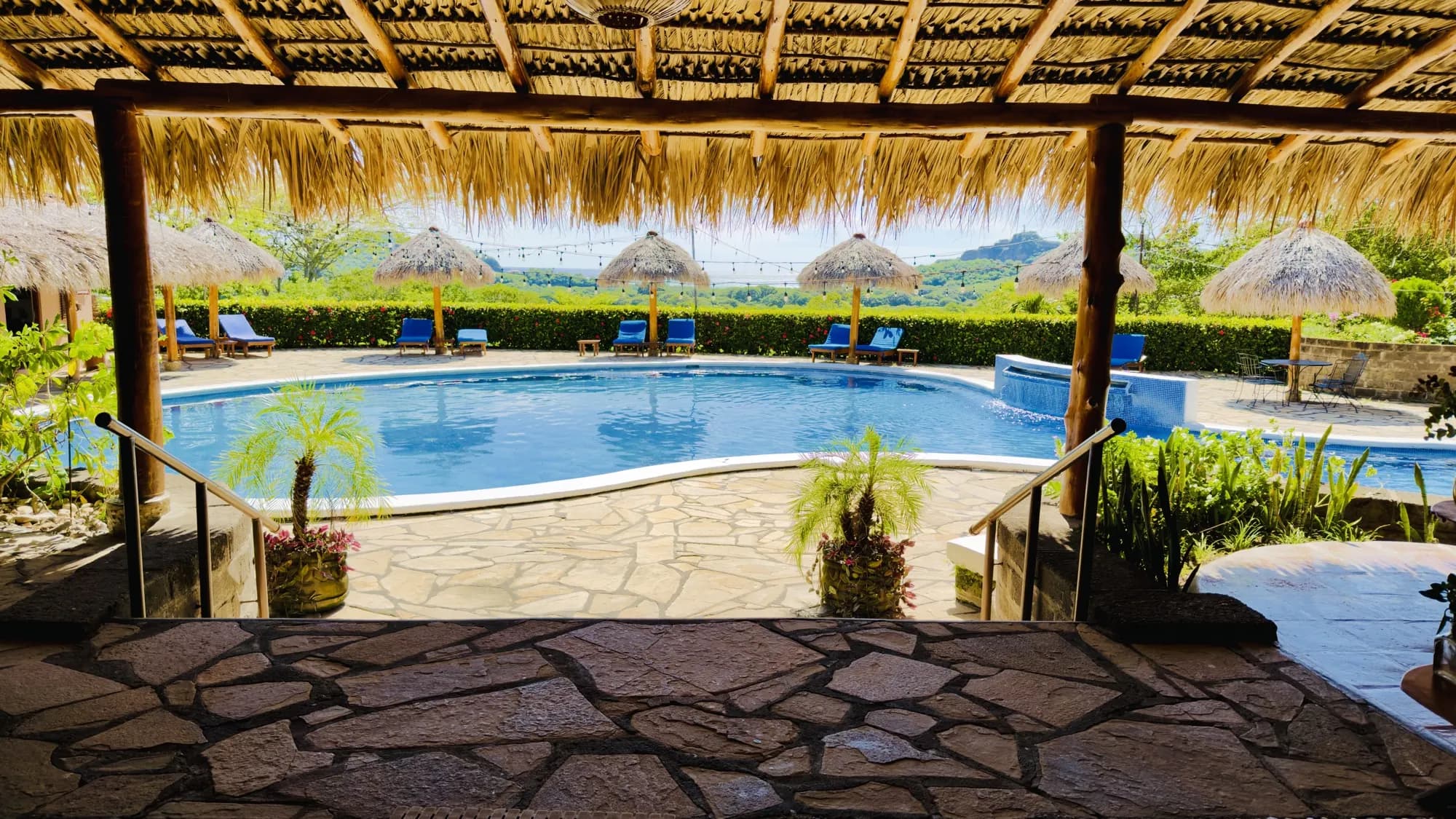 The pool seen from under the restaurant's thatched roof