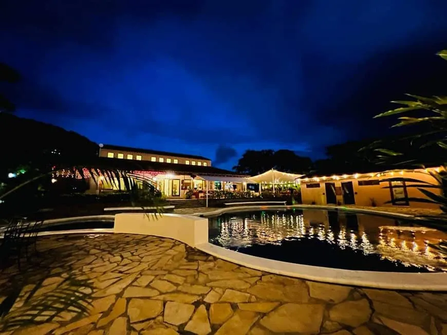 The pool and terrace lit up at night