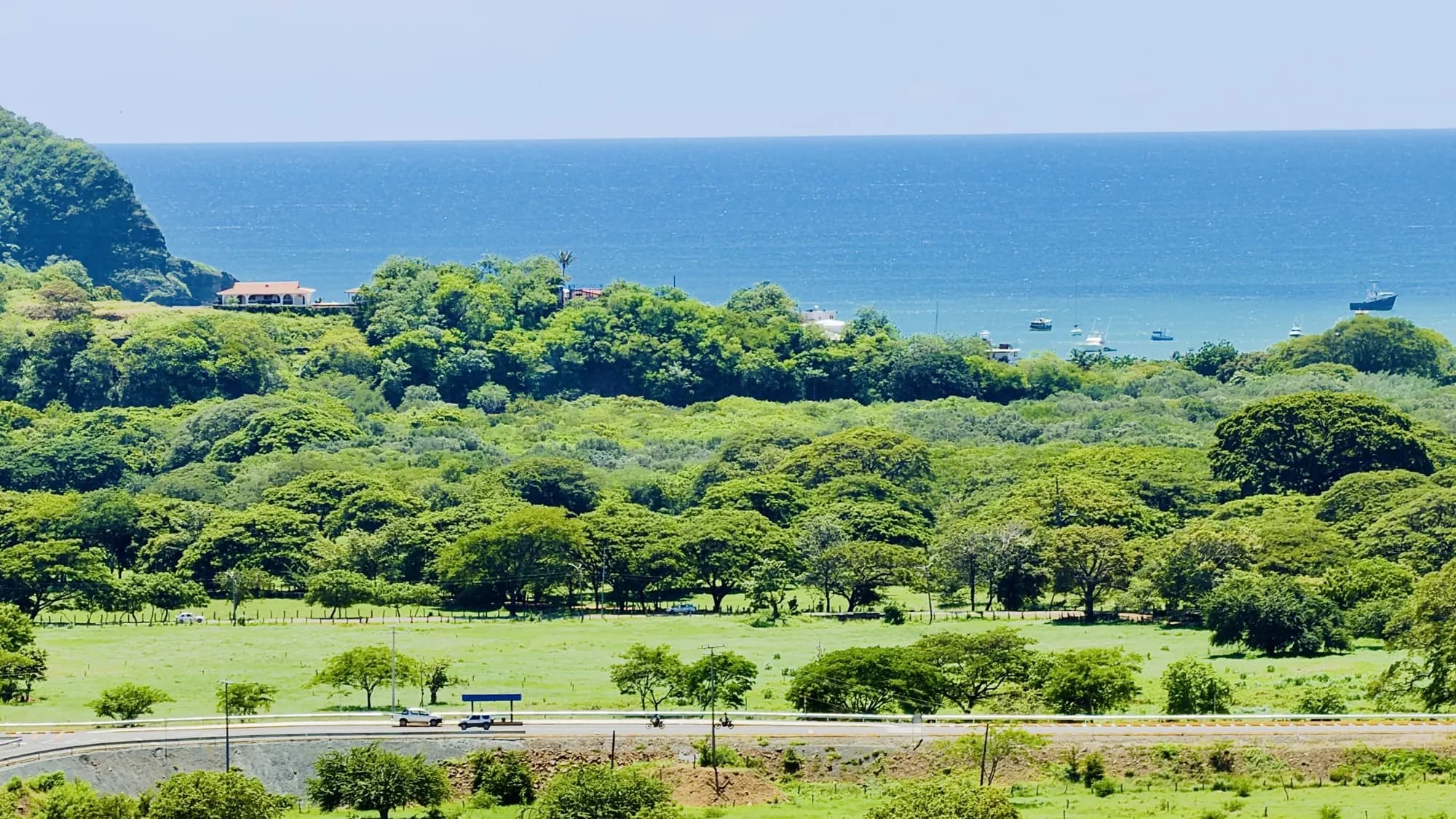 The bay of San Juan del Sur beyond the green valley