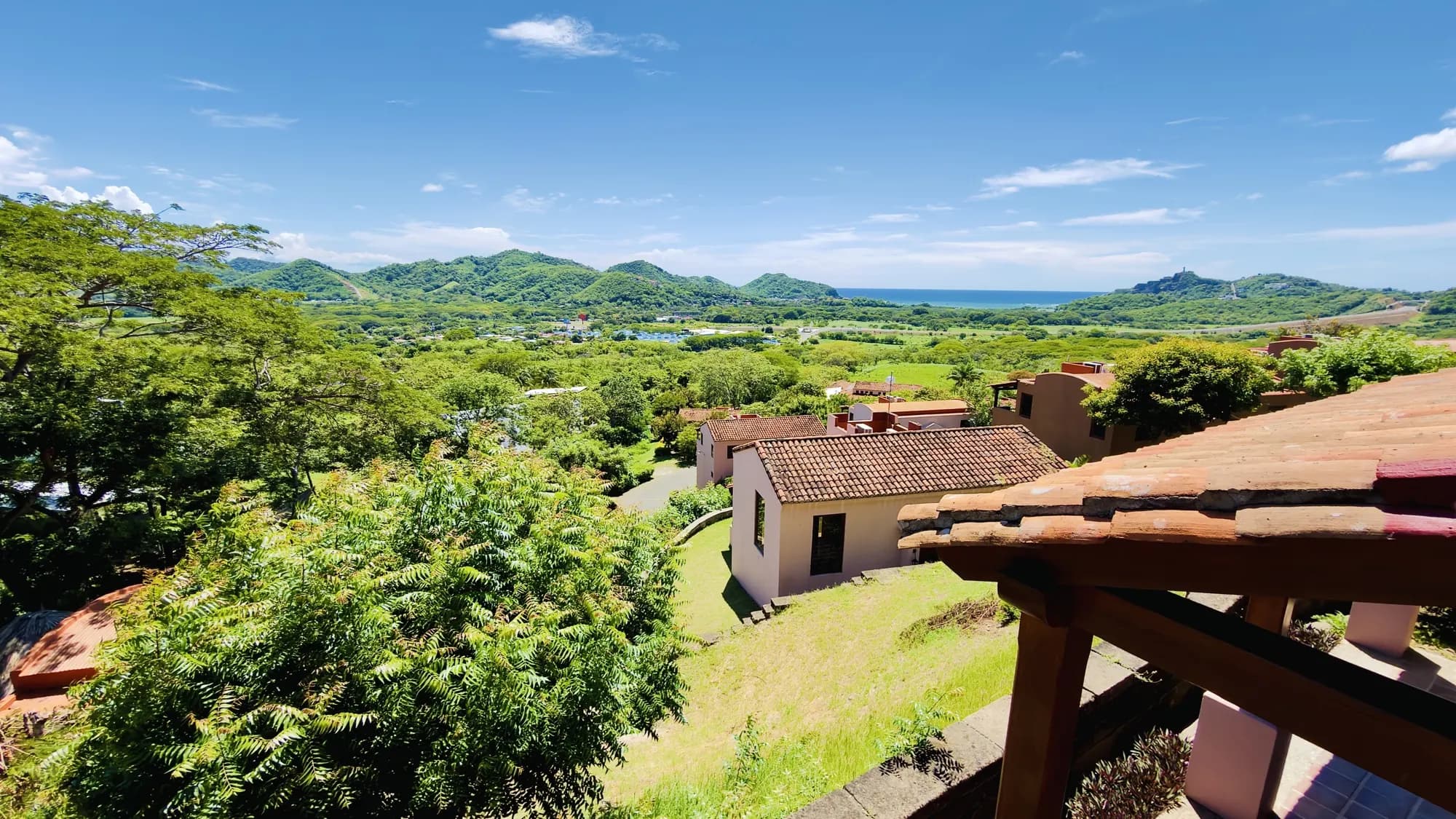 The resort's rooftops and the hills toward the sea