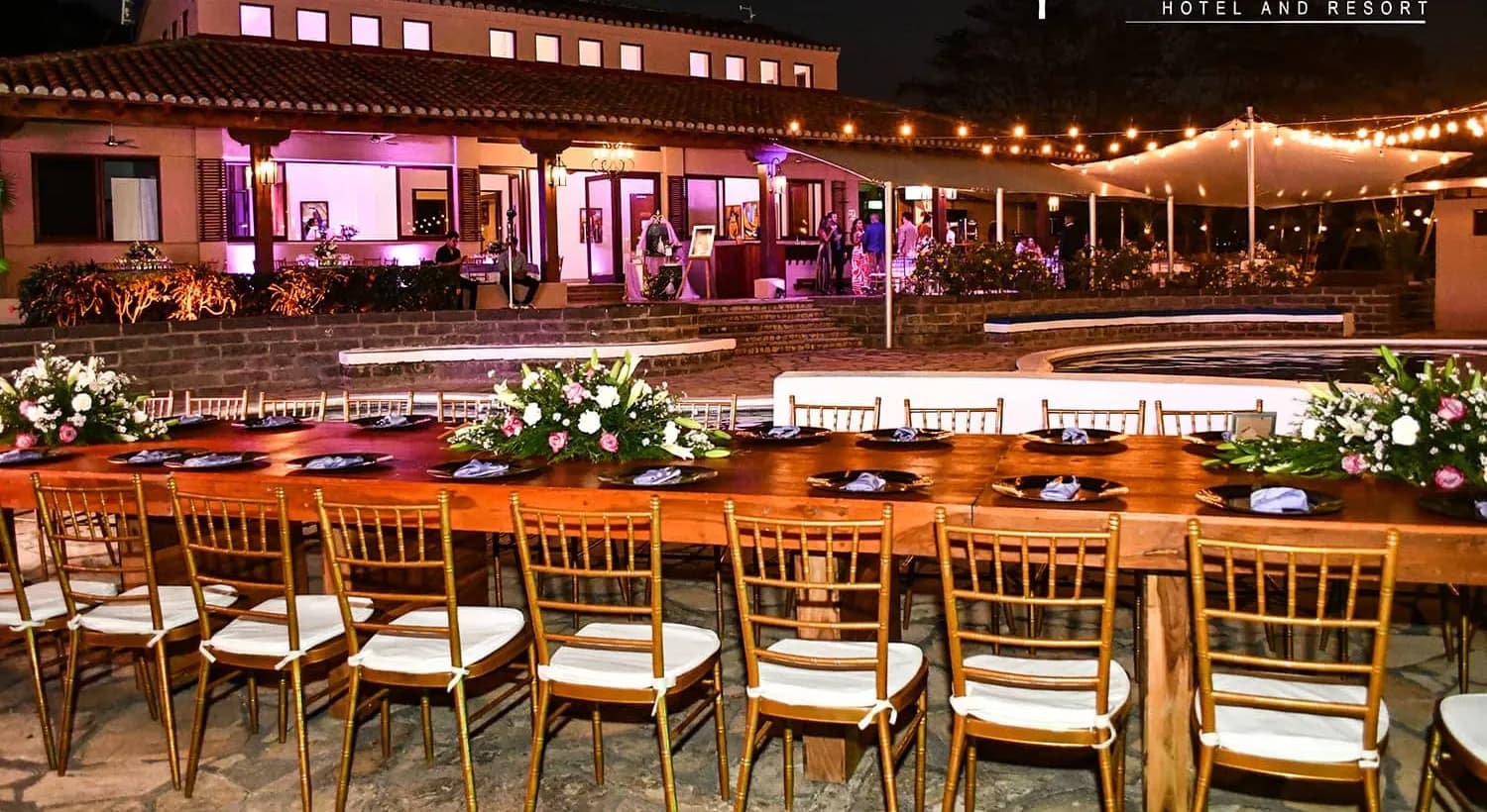 A long table set for an evening event on the terrace