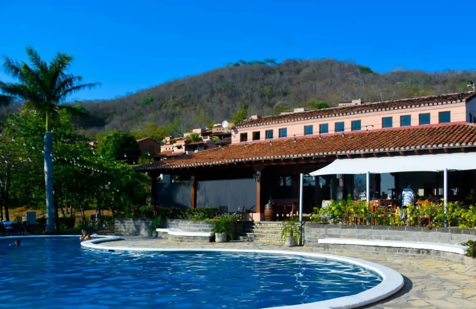 The pool beside the main building and the restaurant