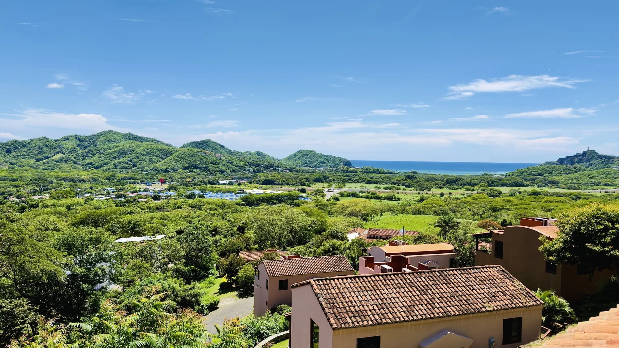 Tile roofs of the villas, the green valley and the Pacific
