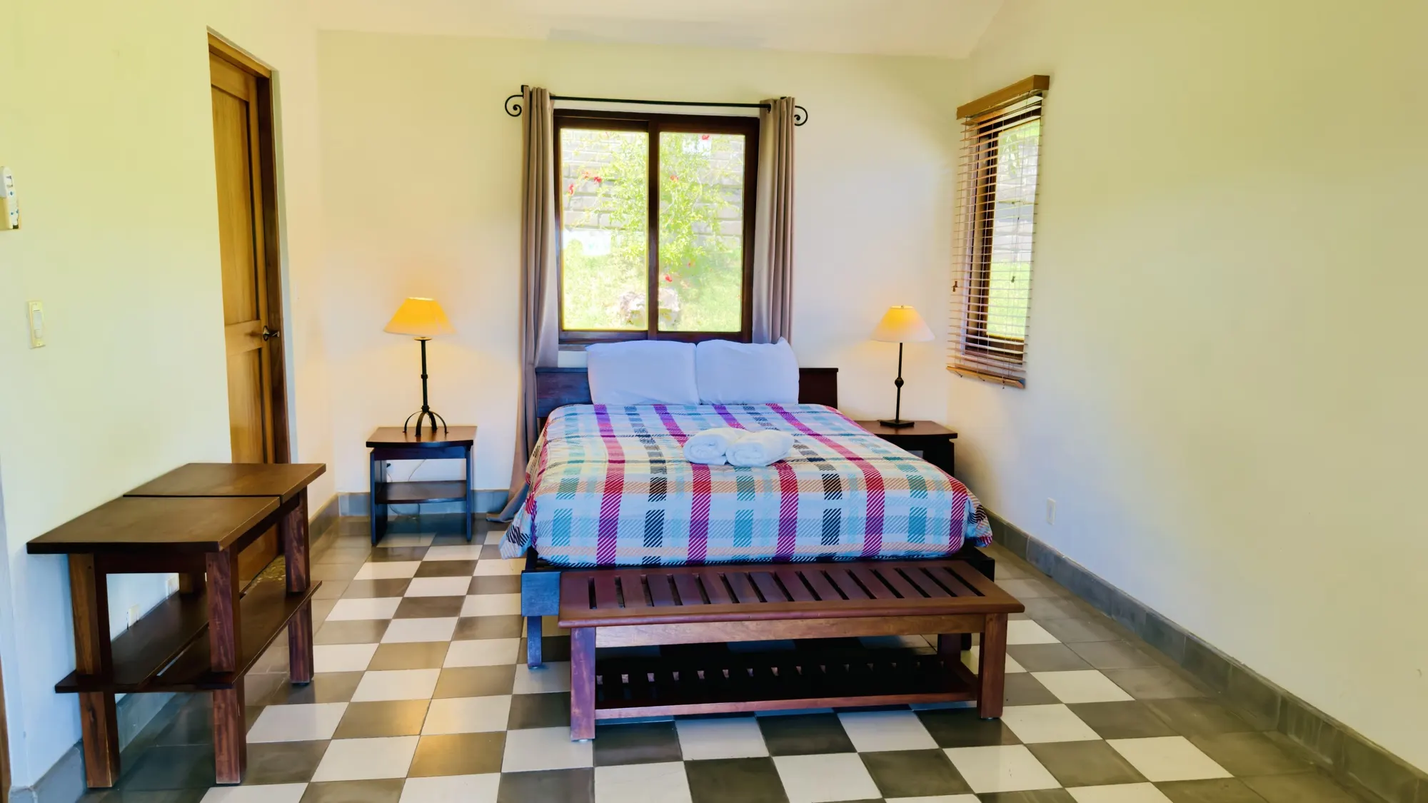 Bedroom with a queen bed, hardwood furniture and tiled floor