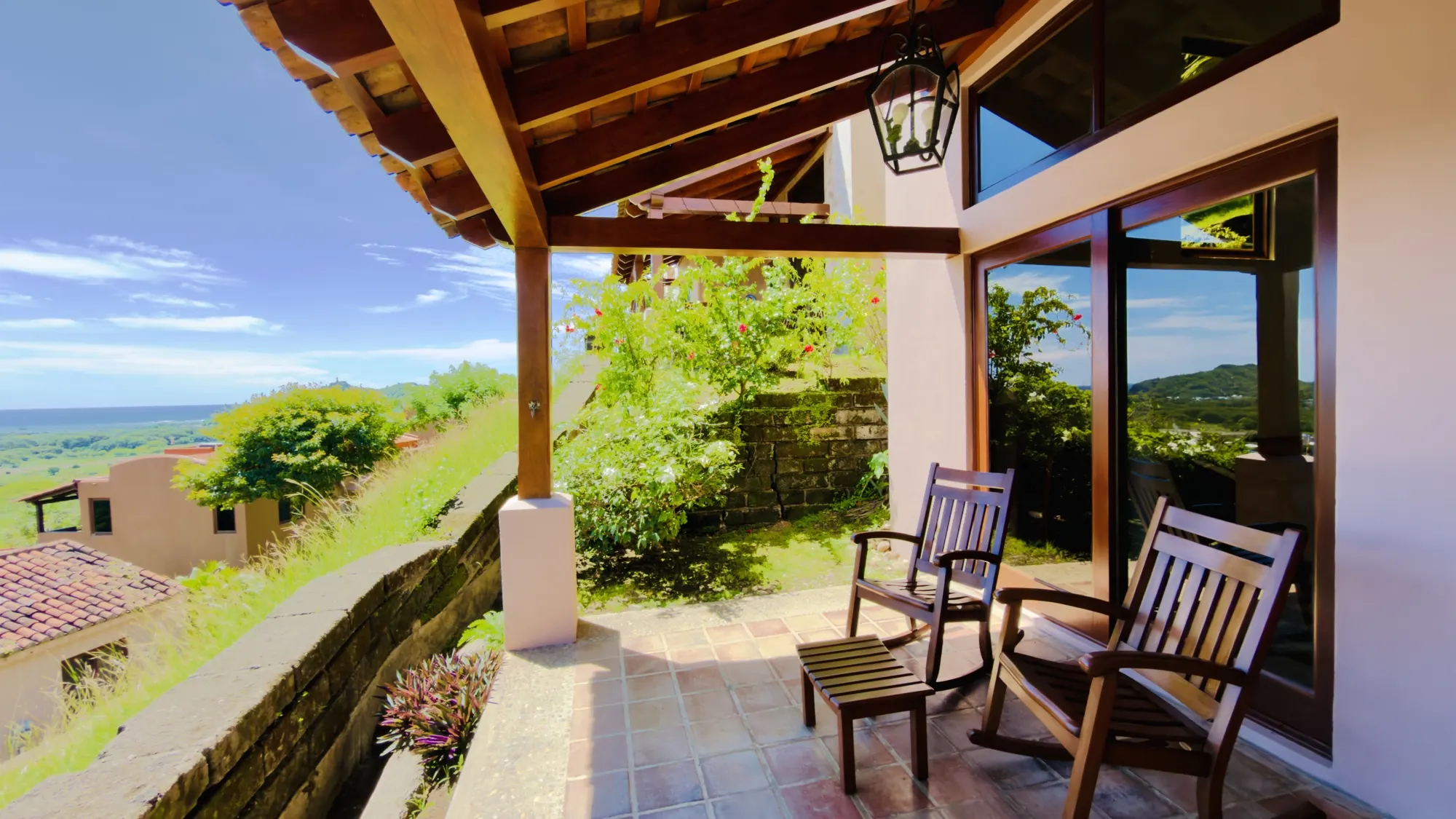 Terrace chairs outside a villa's glass doors